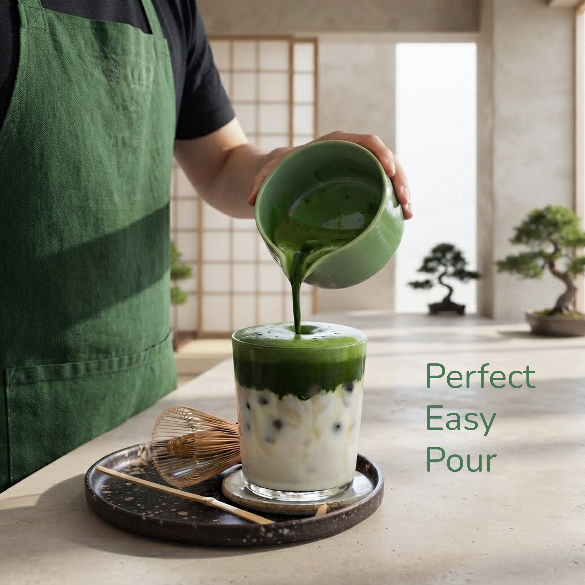 Person pouring matcha in to an iced latte, with the tecxt Perfect easy pour