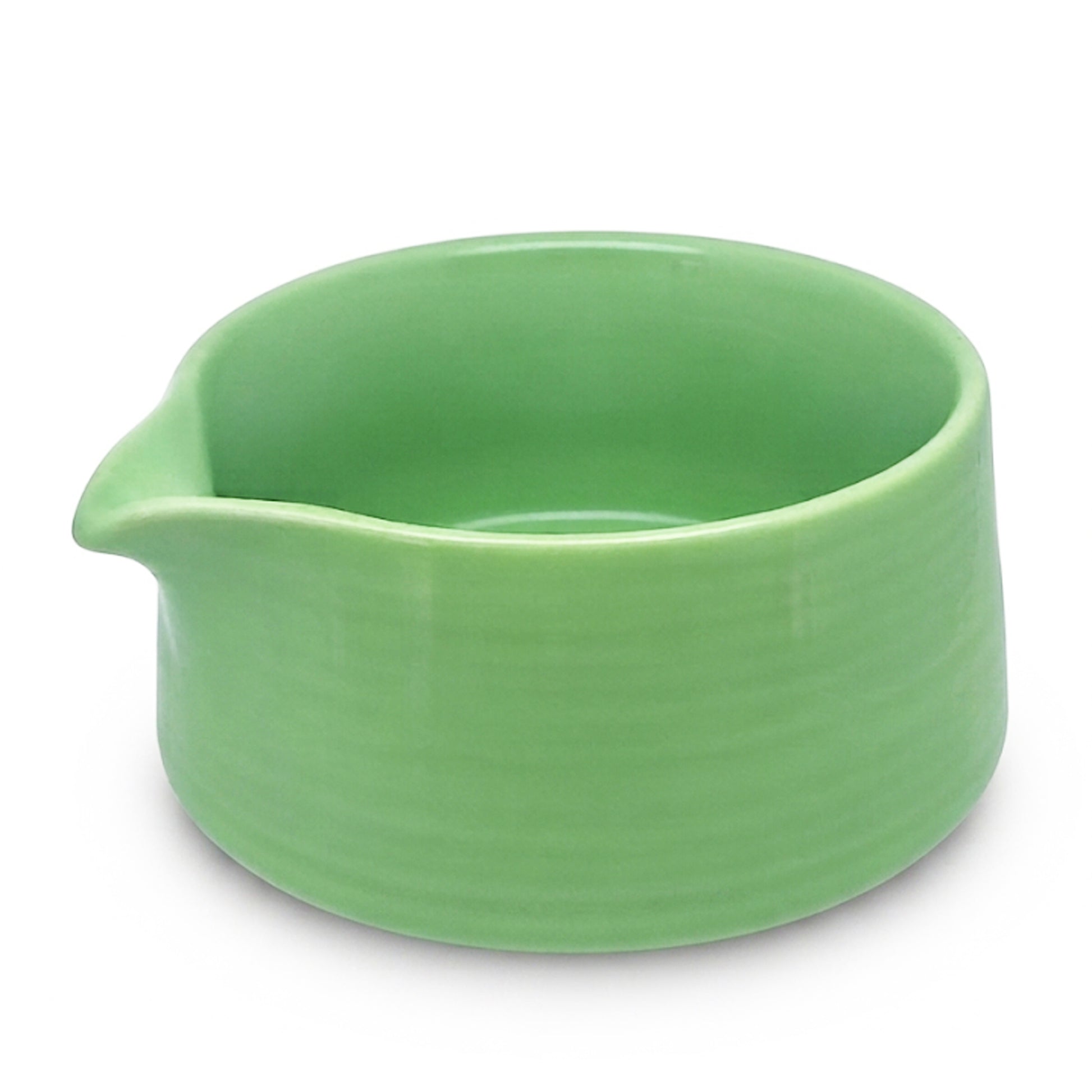 A light green ceramic bowl with a small pouring spout, shown on a clean white background.