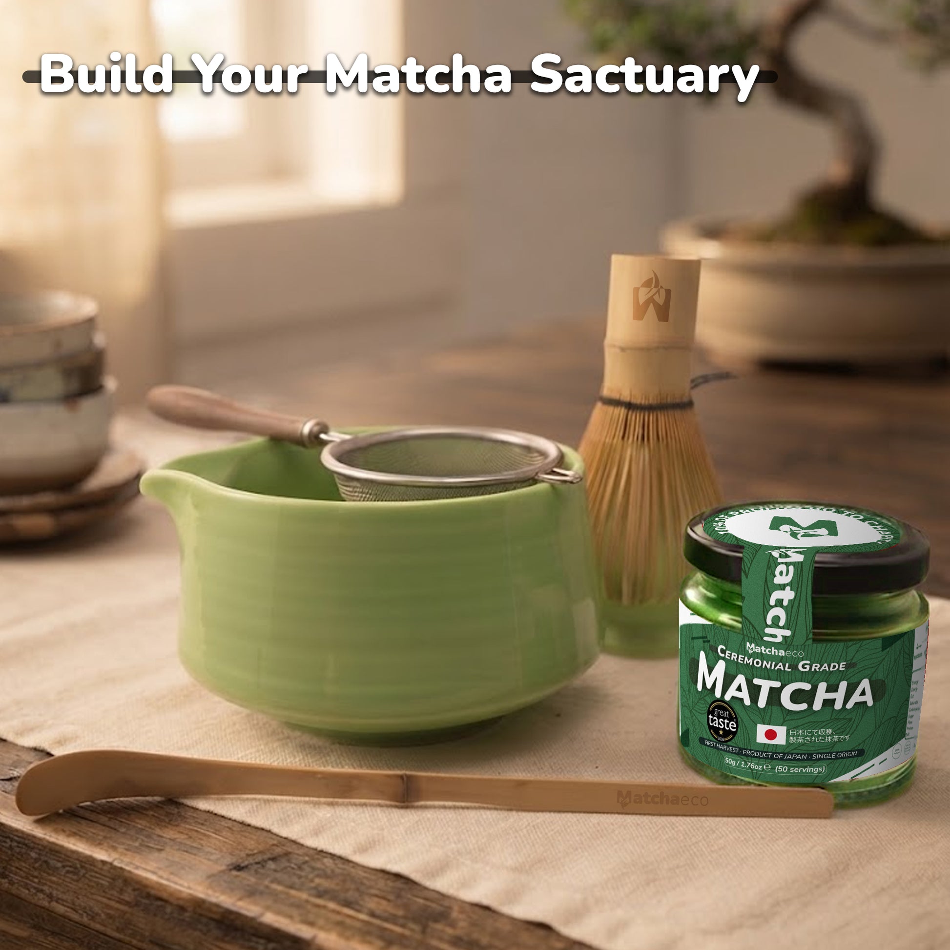 A styled matcha tea preparation setup on a wooden table with a light green ceramic bowl, metal strainer, bamboo whisk, bamboo scoop, and a jar of Matcha green tea. The text 'Build Your Matcha Sactuary' is overlaid at the top.